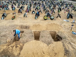 A grave digger prepares the ground for a funeral at a cemetery in Irpin, Ukraine on April 21, 2022. "We are now seeing a deliberate and systematic plan to wipe out the Ukrainian nation," one scholar says.