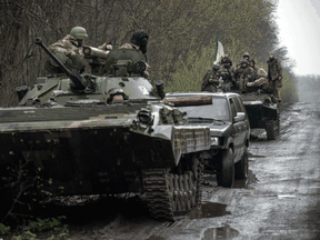 Ukrainian soldiers sit on top of tanks in Eastern Ukraine. The next phase of the war with Russia will feature battles on open plains where Ukraine will need a greater supply of tanks and other heavy armour to limit Russian advances.