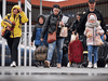 People pass through Przemysl train station while fleeing from war-torn Ukraine on April 9, 2022. As the fighting in Ukraine shifts to the eastern and southern regions of the country, an increasing number of displaced people are emboldened to return home every day.