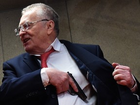 The leader of the Liberal Democratic Party of Russia, Vladimir Zhirinovsky ,tests a gun at the Private Security Training Center in Moscow on March 10, 2018.