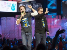 Craig Kielburger and Marc Kielburger, shown here during a Toronto WE Day in 2014, were surprised to hear their organization had been chosen to administer a summer jobs program.