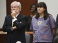 Andrea Yates stands with her attorney George Parnham as the not guilty by reason of insanity verdict is read in her retrial 26 July, 2006 in Houston, Texas.
