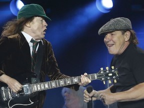 Angus Young of AC/DC bunny hops past Brian Johnson during Shoot to Thrill to 40,000 fans at Downsview Park in Toronto in 2015.