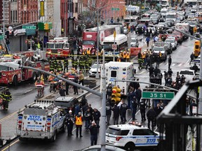 Members of the New York Police Department and emergency vehicles crowd the streets after at least 13 people were injured during a rush-hour shooting at a subway station in the New York borough of Brooklyn on April 12.