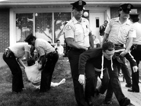 Police carry protesters away from Dr. Henry Morgentaler's clinic in Montreal on May 26, 1989.
