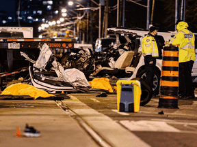 Police at the scene of a fatal collision in the west end of Toronto on Thursday, March 31, 2022. Two pedestrians -- a 75-year-old man and 43-year-old woman -- as well as the driver died at the scene.