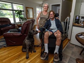 Ken Elliott, his wife Linda Brooks and their dog Roxy in their renovated Lake Bonavista home. Elliott was paralyzed after being shot during a home invasion while on vacation in Barbados.