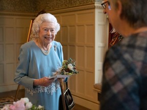 Queen Elizabeth II talks to members of the West Norfolk Befriending Society.