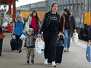 Ukrainian refugees arrive at a train station in Przemysl, Poland, after fleeing the Russian invasion of Ukraine, April 1, 2022.