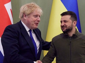 Ukraine's President Volodymyr Zelenskiy and British Prime Minister Boris Johnson shake hands before a meeting, as Russia's attack on Ukraine continues, in Kyiv, April 9.