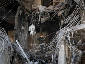 A rescuer stands in an apartment building destroyed in a military strike in Kyiv, April 29.