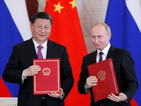 Russian President Vladimir Putin, right, and his Chinese counterpart, Xi Jinping, pose for a photo after a signing ceremony in Moscow, in 2019.