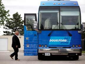 Ontario Progressive Conservative Leader Doug Ford boards his campaign bus in Brampton, Ont., on May 25.