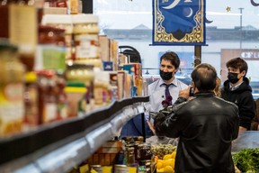 Justin Trudeau and his son Xavier James Trudeau visit newly resettled families from Afghanistan, at Eastern Food Market in Hamilton, Ontario, on May 6, 2022.