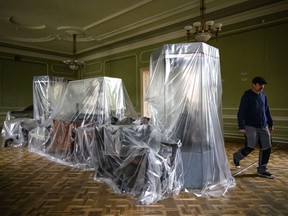 LVIV, UKRAINE - APRIL 29: Robert Saller, an artist who works in the exhibitions department, walks past some of the last remaining objects in the empty galleries and corridors of Potocki Palace, home of the National Borys Voznytsky Gallery, on April 29, 2022 in Lviv, Ukraine.