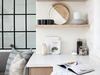 Floating shelves display pretty wares and break up the kitchen’s solid cabinetry.