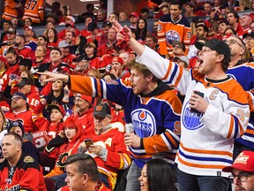 Edmonton Oilers fans celebrate after Zach Hyman #18 scored against the Calgary Flames during the second period of Game One of the Second Round of the 2022 Stanley Cup Playoffs at Scotiabank Saddledome on May 18, 2022 in Calgary.