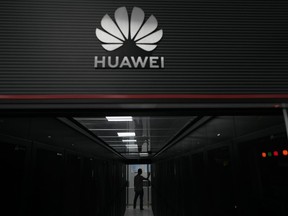 A technician stands at the entrance to a Huawei 5G data server centre at the Guangdong Second Provincial General Hospital in Guangzhou, in southern China's Guangdong province on Sept. 26, 2021. Senior government officials say the Liberals have decided to ban Chinese the vendor Huawei Technologies from Canada's long-awaited blueprint for next-generation mobile networks.