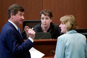 Ben Chew, left, attorney representing Depp, and Elaine Bredehoft, right, attorney representing Heard, speak to Judge Azcarate during the trial on May 2, 2022.