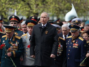 Russian President Vladimir Putin attends a flower-laying ceremony at the Tomb of the Unknown Soldier after the Victory Day military parade in central Moscow on May 9, 2022. - Russia celebrates the 77th anniversary of the victory over Nazi Germany during World War II.