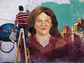 Palestinian artists paint a mural in honour of slain veteran Al-Jazeera journalist Shireen Abu Akleh in Gaza City on May 12, 2022.