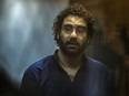 In this file photo taken on May 23, 2015, Egyptian activist and blogger Alaa Abdel Fattah looks on from behind the defendant's cage during his trial in Cairo for insulting the judiciary.
KHALED DESOUKI/AFP via Getty Images