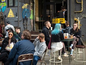 Ukrainians enjoy the sunshine at the BGRN café in Kyiv on May 3, 2022. The Ukrainian capital is beginning to return to life, despite Russia's continuing attack on the country, writes Adam Zivo.