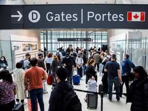 Travellers crowd the security queue in the departures lounge at Toronto Pearson International Airport on May 20.