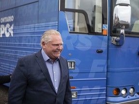 Ontario Premier Doug Ford arrives in his campaign bus to speak to the media at a construction site in Brampton, Ont. as he starts his re-election campaign, on Wednesday, May 4, 2022.