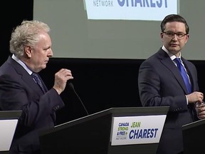 Jean Charest and Pierre Poilievre during the Conservative leadership debate on Thursday, May 5, 2022.