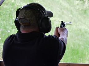 A man fires a handgun at the Claybird Gun Club in Exeter, Ont.