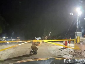 A surveillance camera captures an attacker lighting off a flare during the attack on the Coastal GasLink camp near Houston on Feb. 17, 2022. The attackers disabled the cameras a short time later.