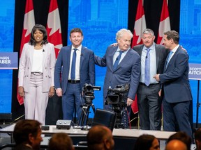 Conservative leadership candidate Scott Aitchison, second from right, stands alongside, from left, Leslyn Lewis, Roman Baber, Jean Charest and Patrick Brown, after the Conservative Party of Canada English leadership debate on May 11 in Edmonton.