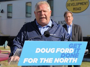 Ontario Progressive Conservative Leader Doug Ford takes questions from local media while George Pirie, the PC candidate for Timmins looks on, on May 8, 2022.