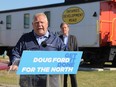 Ontario Progressive Conservative Leader Doug Ford takes questions from local media with George Pirie, the PC candidate for Timmins riding, in the background on Sunday, May 8, 2022.