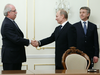 Novatek CEO Leonid Mikhelson (R) watches Vladimir Putin (C) shake hands with Christophe De Margerie (L), CEO of France’s oil giant Total, in Putin’s residence outside Moscow, on March 2, 2011.