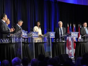 Conservative leadership candidates, from left, Pierre Poilievre, Patrick Brown, Scott Aitchison, Leslyn Lewis, Jean Charest and Roman Baber take part in the Conservative Party of Canada French-language leadership debate in Laval, Quebec on May 25, 2022.