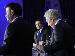 Candidates Roman Baber, left, Pierre Poilievre and Jean Charest, right, take part in the French language Conservative Leadership debate Wednesday, May 25, 2022 in Laval, Que.