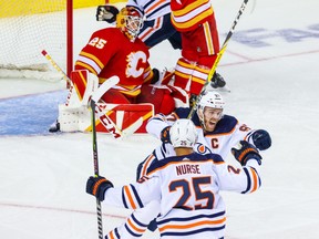 Edmonton Oilers centre Connor McDavid (97) celebrates his overtime goal against Calgary Flames goaltender Jacob Markstrom (25), in game five of the second round of the 2022 Stanley Cup Playoffs at Scotiabank Saddledome in Calgary on May 26.