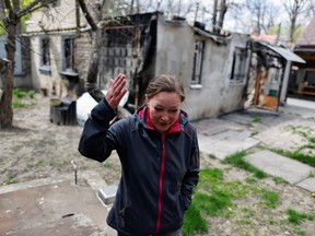 A woman walks away from her house in Irpin, Ukraine, which she says was destroyed by Russian shelling.