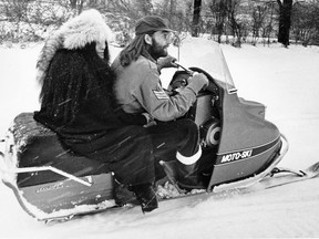 John Lennon and his wife Yoko, take their first ride on a snowmobile on Dec. 18, 1969 on a farm owned by rockabilly singer Ronnie Hawkins near Mississauga, Ontario.