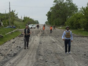 Aid workers in accompanied by Ukrainian soldiers near Kharkiv. Photo by Adam Zivo.