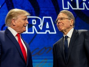Former U.S. President Donald Trump greets CEO and Executive vice president of the National Rifle Association (NRA) Wayne LaPierre during the National Rifle Association annual convention at the George R. Brown Convention Center on May 27, 2022 in Houston, Texas.