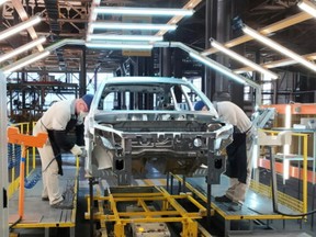 Employees work at the assembly line of the LADA Izhevsk automobile plant, part of the Avtovaz Group, in Izhevsk, Russia February 22, 2022.