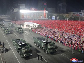 A massive crowd watches as missile-carrying vehicles take part in a nighttime military parade to mark the 90th anniversary of the founding of the Korean People's Revolutionary Army in Pyongyang, North Korea, in a photo released on April 26, 2022.