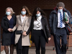 Lisa Banfield, second from left, spouse of Gabriel Wortman, is escorted by friends along with lawyer James Lockyer, right, as they leave Nova Scotia Provincial court in Dartmouth on Wednesday, March 9, 2022. Banfield's lawyer withdrew her not guilty plea to charges related to illegally transferring ammunition to Wortman.