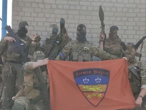 Members of the Norman Brigade, a Canadian-led unit of foreign fighters, in Ukraine, with the photo altered to hide their identities.