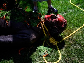 Activists topple a statue of Sir John A. Macdonald in Hamilton, Ont., in 2021.