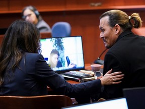 Camille Vasquez reaches out to Johnny Depp during the trial.