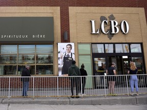 People line up, socially distanced, outside an Ontario liquor store during the early days of the COVID pandemic, in April 2020.